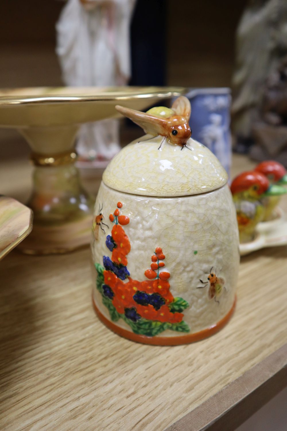 A Victorian John Bevington earthenware female figure, a Japanese cruet and a honey pot in Clarice Cliff style, and four other items